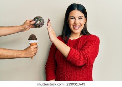 Beautiful Brunette Woman Saying No To Sweets On A Healthy Diet Smiling With A Happy And Cool Smile On Face. Showing Teeth. 
