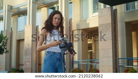 Similar – Image, Stock Photo Girl using electric scooter in the street in downtown rented by using service on smartphone. Candid people, real moments, authentic situations