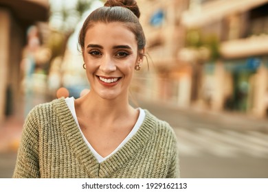 Beautiful brunette woman smiling happy and confident outdoors at the city on a sunny day of autumn