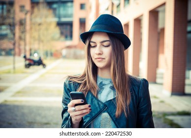 beautiful brunette young woman in the city - Shutterstock ID 220472530
