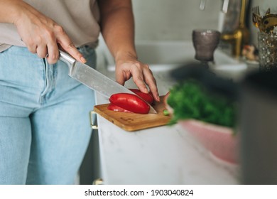 Beautiful Brunette Young Woman Plus Size Body Positive Cooking Salad In Kitchen At Home