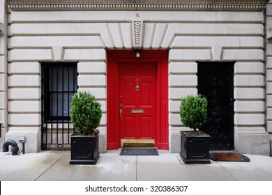 Beautiful Building. Entrance Red Door, Manhattan New York, USA. Classic Apartment Estate In New York City. Beautiful View Of Midtown Property, NYC. Business And Finance, Luxury Life Background.