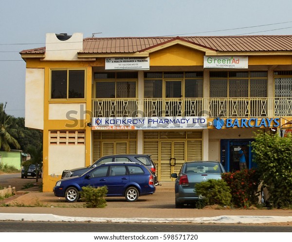 Beautiful building of a pharmacy and a branch of\
Barclays Bank in Accra. Architecture and Construction industry in\
West Africa. Bank industry in Ghana. Ghana, Accra - January 19,\
2017