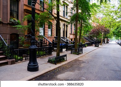 Beautiful buildings in Greenwich Village, Soho district. Entrance doors with stairs and trees, Manhattan New York. Classic luxury apartment building in New York City. Beautiful american street.