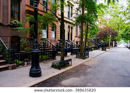 Beautiful buildings in Greenwich Village, Soho district. Entrance doors with stairs and trees, Manhattan New York. Classic luxury apartment building in New York City. Beautiful american street.