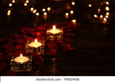 Beautiful burning candles with red roses petals on dark bokeh background with copy space. Valentine's day romantic concept. Romantic spa - Powered by Shutterstock