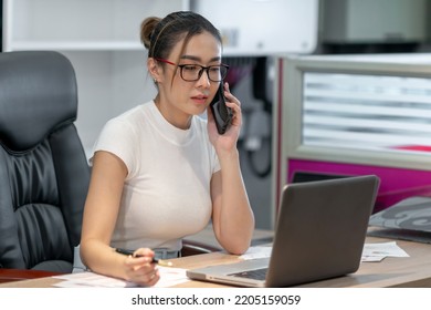 Beautiful Business Asian Woman Using Phone. Female Employee Having A Conference Talking Online With Smartphone Call. A Serious Professional Office Woman Having Internet Cellphone Meeting Conversation.