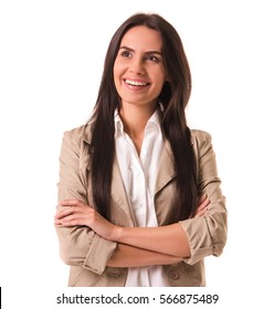 Beautiful Business Lady In Beige Suit Is Standing With Crossed Arms, Looking Away And Smiling, Isolated On White