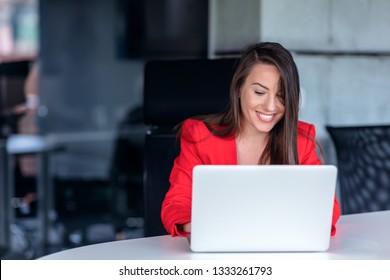 Beautiful Business Lady With Laptop Computer In Office.