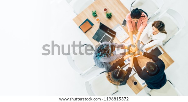 Beautiful Business People Join Hand Together. Cross
Processing of Smart People Indoors. Team Work Concept. Successful
Business People Teamwork Collaboration Relation Concept. Top
View.