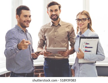 Beautiful Business People Are Looking At Camera And Smiling While Standing In Office