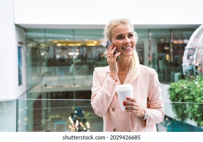 Beautiful Business Woman At The Airport Leaving On For A Working Travel. Using Smartphone To Make A Phonecall