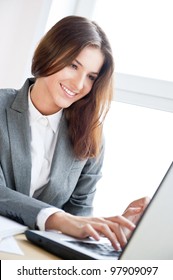 Beautiful Business Woman Dreaming While Working On Computer At Her Office