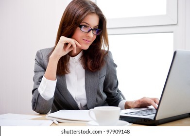 Beautiful Business Woman Dreaming While Working On Computer At Her Office