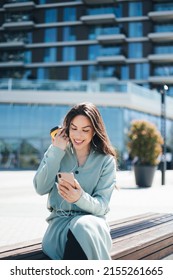 Beautiful Business Woman Enjoying Coffee Break On Free Time Outdoor With Favorite Music In Earphones, Millenial Female Listening Audio Book On Mobile App 