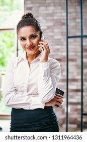 Beautiful Business Woman Has A Work Conversation Over A Cell. Portrait Of Smiling Woman In Formal Cloth Talking On Smartphone. - Shutterstock ID 1311964436