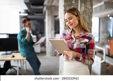 Beautiful business woman holding tablet computer in office - Shutterstock ID 1843533961