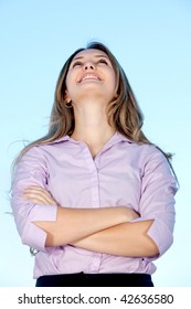 Beautiful Business Woman Looking Up With Arms Crossed