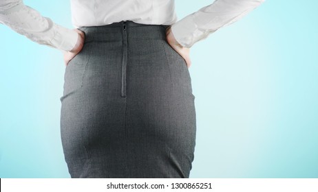 Beautiful business woman on a colored background. close-up skirt. dress code, move the hips.