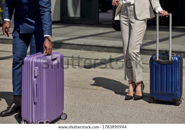 beautiful business woman and personal transfer\
near hotel, confident affable taxi driver or transfer help woman to\
carry baggage and lead her to the\
car