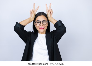 Beautiful Business Woman Posing Funny And Crazy With Fingers On Head As Bunny Ears, Smiling Cheerful