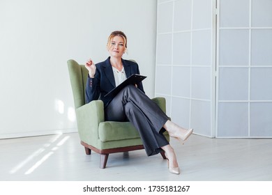 Beautiful Business Woman Psychologist Sits In Green Chair