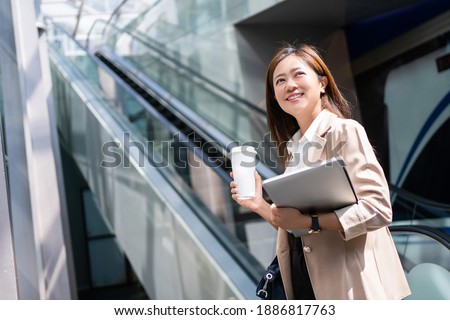 Beautiful business woman, she is going to work in the morning on the subway.
