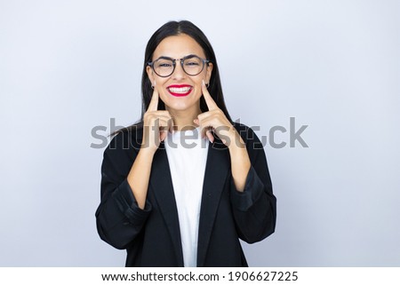 Beautiful business woman smiling confident showing and pointing with fingers teeth and mouth