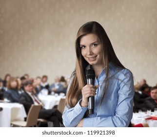 Beautiful business woman is speaking on conference.
