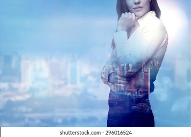 A Beautiful Business Woman Is Thinking About Business Solutions. City View In Blur As A Background.