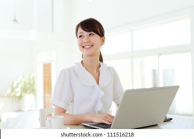 Beautiful Business Woman Using A Laptop Computer. Portrait Of Asian.