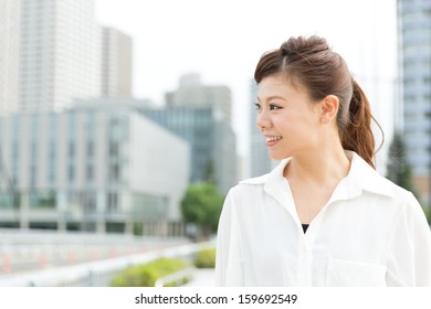 Beautiful Business Woman Walking Outside Her Office. Portrait Of Asian. 