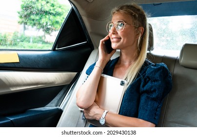 Beautiful Business Women Driving To The Airport,leaving On For A Working Travel. Using Smartphone To Make A Phonecall