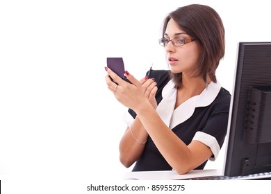 Beautiful Businesswoman Applying Lipstick Using Lip Concealer Brush In The Office