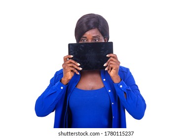 beautiful businesswoman in blue shirt standing on white background presenting a tablet near the face. - Powered by Shutterstock