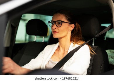 Beautiful Businesswoman Driving A Car. Portrait Of Smiling Woman Sitting In The Car	