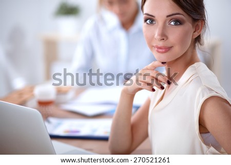 Beautiful  businesswoman enjoying coffee in bright office, sitting