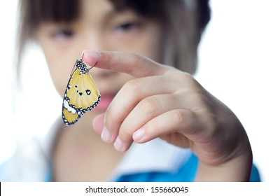Beautiful butterfly sitting on the girl hand