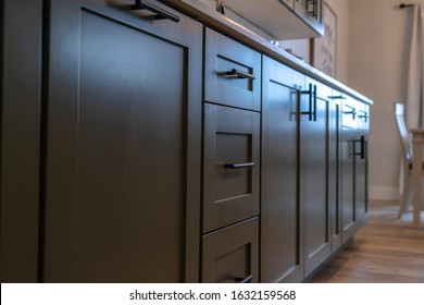 Beautiful cabinetry with black handles and drawers under white countertop - Shutterstock ID 1632159568