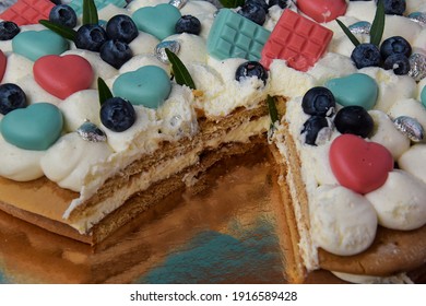 Beautiful Cake Decorated With Berries, Cut A Piece Of Cake. Cake On A Gold Background. Birthday, Holiday Baked Goods.