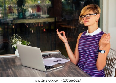 beautiful and calm business woman sitting at a table with a laptop in a summer cafe in the lotus position meditating and relaxing.freelance girl remote work tropics beach paradise - Shutterstock ID 1333665827