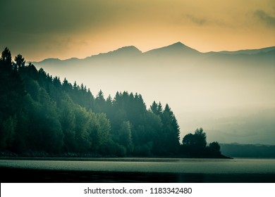 A beautiful, calm morning landscape of lake and mountains in the distance. Colorful summer scenery with mountain lake in dawn. Tatra mountains in Slovakia, Europe. - Shutterstock ID 1183342480