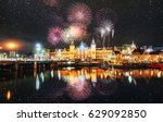 Beautiful calm night view of Amsterdam city. Colorful fireworks on the black sky background. Photo greeting card. Bokeh light effect, soft filter.