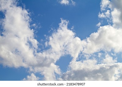 Beautiful, calm and peaceful view of blue sky with stratocumulus clouds and copy space from below. Low angle scenery of white, fluffy and soft cloudscape with heaven theory before forming rainclouds