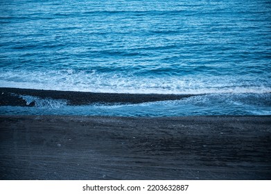 Beautiful Calm And Peaceful Water Flowing With Waves Towards Beach With Green Tall Trees Against Cloudy Blue Sky During Daytime With No People Around