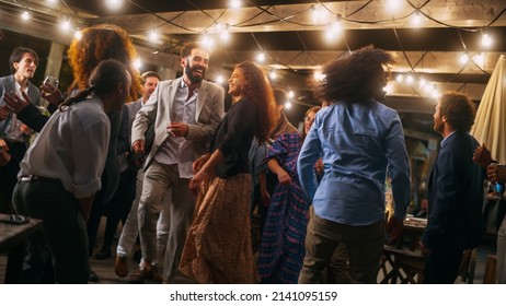 Beautiful Carefree Friends are Dancing Together and Celebrating an Evening Event at a Party . Diverse Multiethnic Young Adult People Have Fun at a Corporate Party in a Restaurant. - Shutterstock ID 2141095159