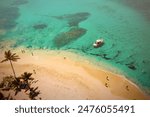 Beautiful caribbean beach in Dominican Republic. Aerial abstract view of tropical idyllic summer landscape with small figures of people, sea coast and white sand