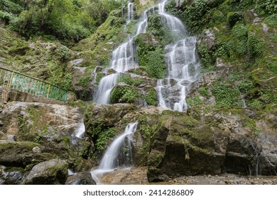 Beautiful cascading Bakthang waterfall in the Himalayan valley in Sikkim, India - Powered by Shutterstock