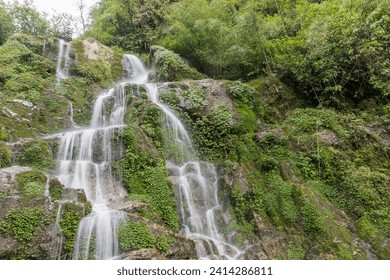 Beautiful cascading Bakthang waterfall in the Himalayan valley in Sikkim, India - Powered by Shutterstock