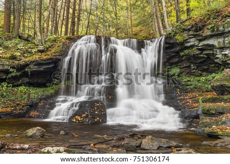 A beautiful cascading waterfall is surrounded by fall foliage on Dry Run in Pennsylvania's Loyalsock State Forest.